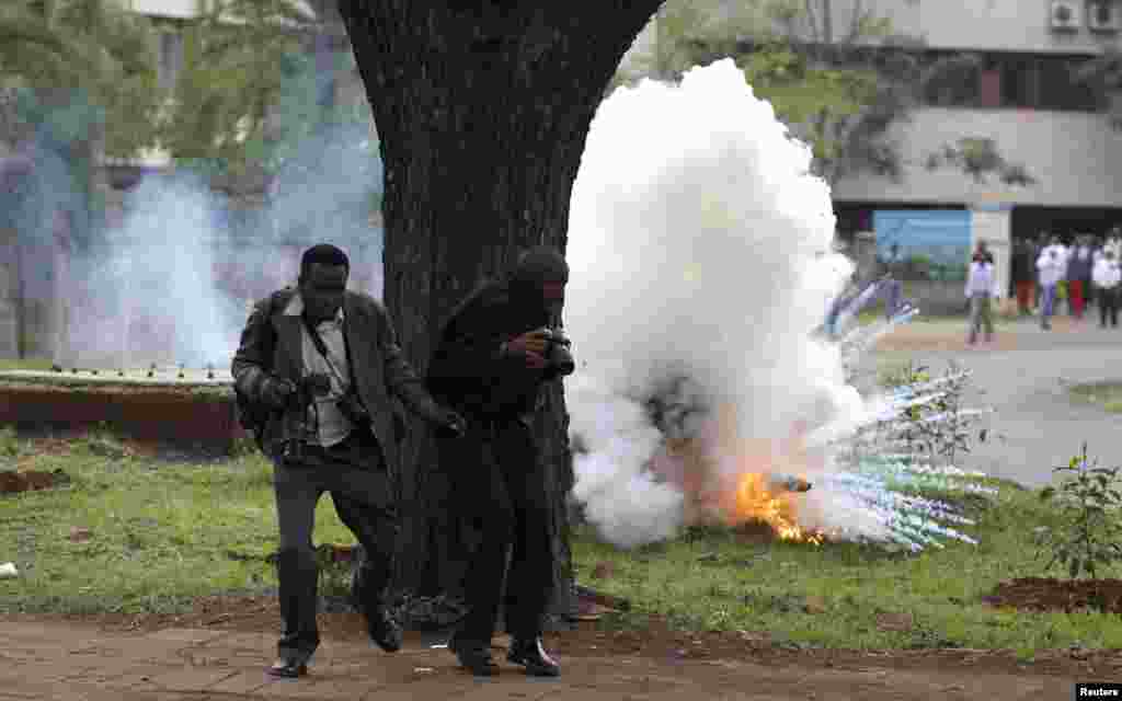 Photojournalists run away from a explosion of a tear gas canister, fired by police in a bid to disperse rioting university students in Kenya&#39;s capital Nairobi. Public university students started their protests, which are against the planned hiking of fees and lowering of maximum loan awarded to students by the Higher Education Loans Board, local media reported.