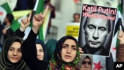 Turkish protesters shout anti-Russia slogans as they hold a poster of Russian President Vladimir Putin during a protest in Istanbul, Turkey, Nov. 27, 2015. (AP Photo/Omer Kuscu) 