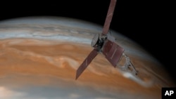 This artist's rendering made available by NASA/JPL-Caltech on July 7, 2015, shows the Juno spacecraft above Jupiter.