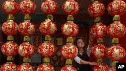 A shopkeeper arranges Chinese New Year decorations in Tainan, southern Taiwan, January 28, 2011