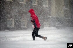 A pedestrian crosses the street in downtown Boston, Jan. 4, 2018.