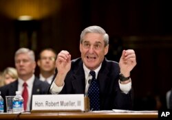 FILE - Then FBI Director Robert Mueller testifies on Capitol Hill in Washington, June 19, 2013, before the Senate Judiciary Committee.