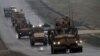 FILE - A convoy of US military vehicles is seen in Syria's northern city of Manbij, Dec. 30, 2018.