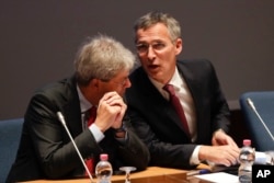 FILE - Italian Foreign Minister Paolo Gentiloni, left, and NATO Secretary General Jens Stoltenberg during "Nato cooperation with Partners in the Mediterranean and Middle East" meeting at the NATO Defense College headquarters, in Rome, Oct. 14, 2016.