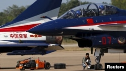 FILE - Pilots of China's J-10 fighter jet from the People's Liberation Army Air Force prepare before a media demonstration at the Korat Royal Thai Air Force Base, Thailand, Nov. 24, 2015. Bangkok is increasingly looking toward Beijing for military hardware purchases.