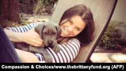 FILE - Brittany Maynard, shown with her Great Dane puppy, Charlie, took a lethal dose of medication prescribed by a doctor in Oregon on Saturday. Maynard was battling brain cancer.