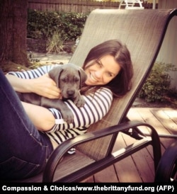 FILE - Cancer patient Brittany Maynard, shown with her Great Dane puppy, took a lethal dose of medication prescribed by a doctor.