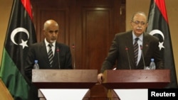 Libya's Prime Minister Abdurrahim El-Keib (R) and Head of the national assembly Mohammed Magarief attend a news conference in Tripoli, September 12, 2012.