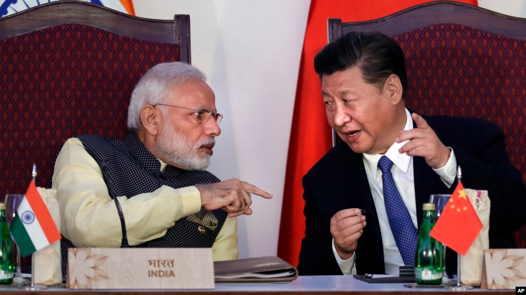 FILE - Indian Prime Minister Narendra Modi, left, talks with Chinese President Xi Jinping during the BRICS summit in Goa, India, Oct. 16, 2016. China and India may have ended a tense border standoff for now, but their longstanding rivalry raises questions