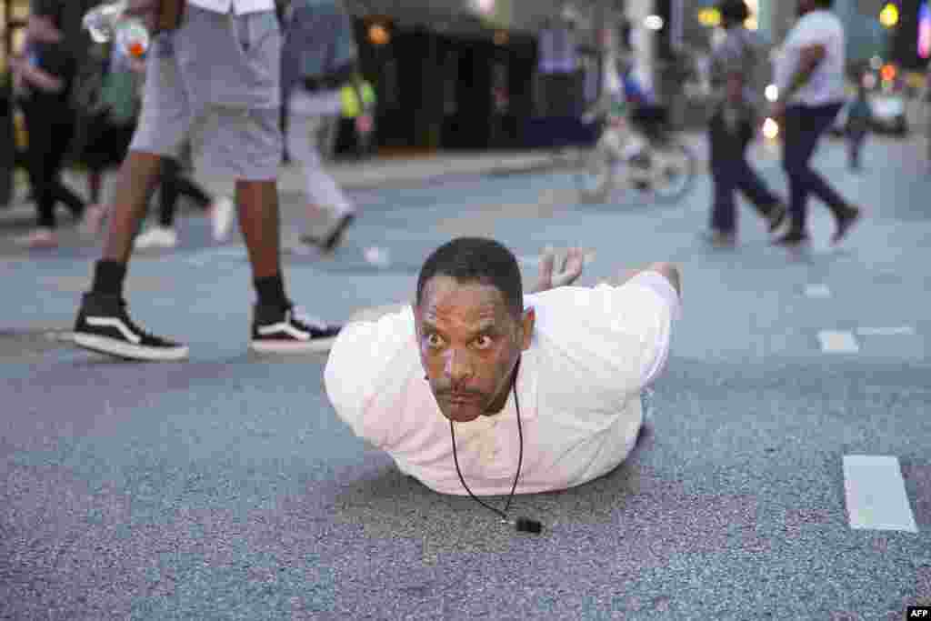 A man lays on the ground after yelling &quot;Don&#39;t shoot me&quot; at police during a rally in Dallas, Texas, on Thursday, July 7, 2016 to protest the deaths of Alton Sterling and Philando Castile.