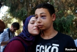 Tariq Khdeir, right, is greeted by his mother after being released from jail in Jerusalem, July 6, 2014.