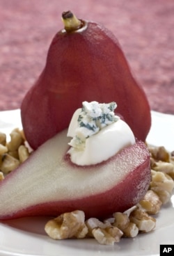 Red wine poached pears with blue cheese and walnuts can be seen in this August 30, 2010 photo. (AP Photo / Larry Crowe)