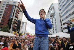 FILE - Presidential candidate Guillermo Lasso speaks during a rally outside the National Electoral Council in Quito, Ecuador, April 3, 2017.