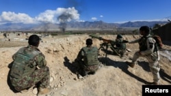 Afghan security forces take position during a gun battle between Taliban and Afghan security forces in Laghman province, Afghanistan, March 1, 2017.