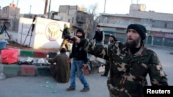 Free Syrian Army fighters are deployed in Kadi Askar, Aleppo after they said they seized it from fighters from the Islamic State in Iraq and the Levant, Jan. 7, 2014.