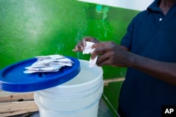 A worker prepares serum at a cholera center in Anse D'Hainault, Haiti, Oct. 11, 2016.