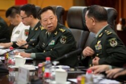 FILE - China's People's Liberation Army (PLA) Gen. Li Zuocheng, center, speaks during a meeting with U.S. Army Chief of Staff Gen. Mark Milley, not shown, at the Bayi Building in Beijing, Aug. 16, 2016.