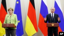 Russian President Vladimir Putin, right, gestures as he and German Chancellor Angela Merkel speak to the media after their talks at Putin's residence in the Russian Black Sea resort of Sochi, Russia, Tuesday, May 2, 2017.