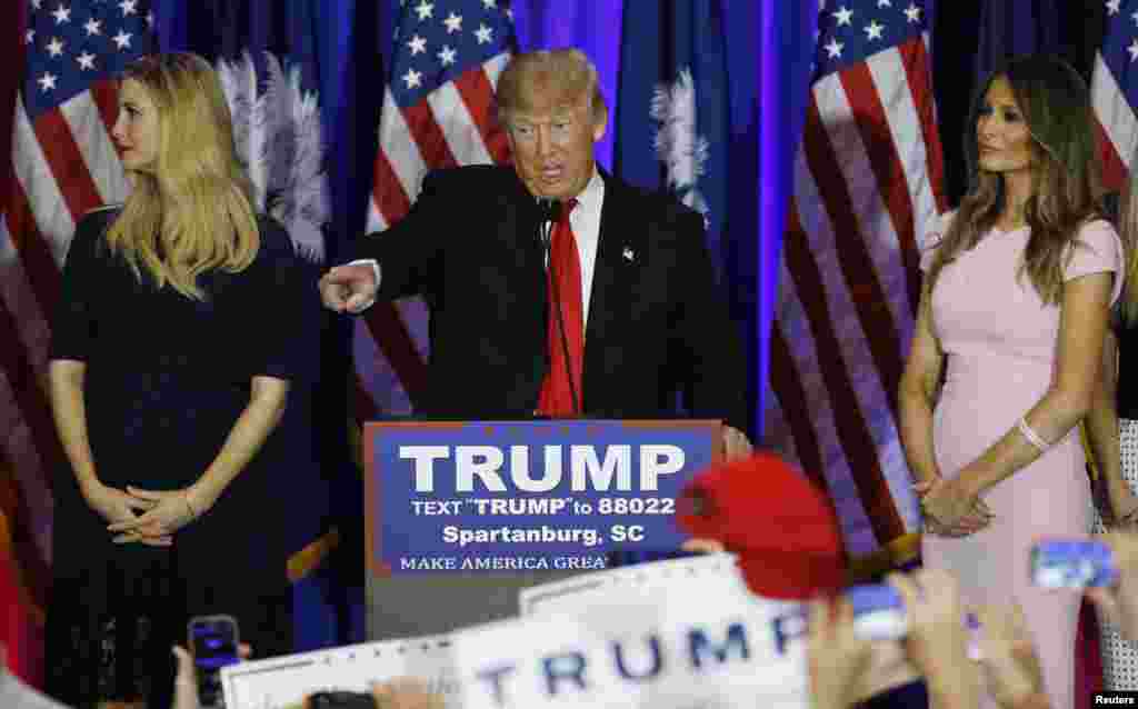 Republican U.S. presidential candidate Donald Trump, center, greets supports at a victory rally in Spartanburg, S.C., Feb. 20, 2016. On stage with Trump are his daughter, Ivanka, left, and his wife, Melania, right.