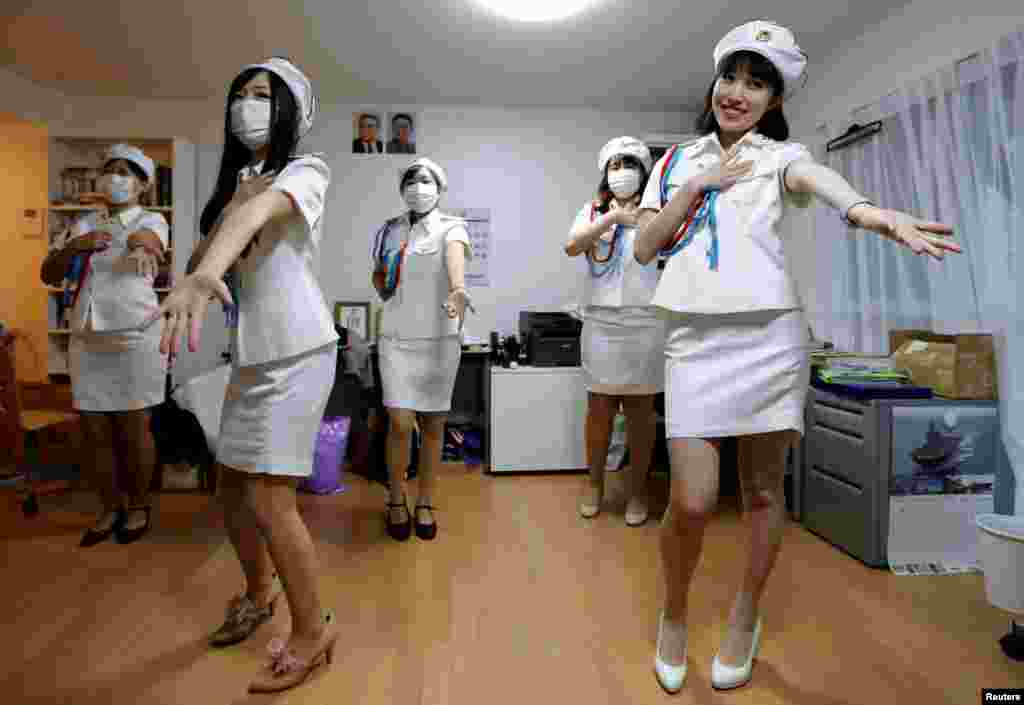 Chunhun (R), the leader of Japan&#39;s North Korea fan club called sengun-joshi, or military-first girls, and other members practice a Moranbong Band dance in Tokyo, Japan.