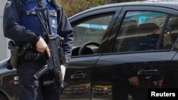 A Belgian police officer controls the access to Belgian international airport of Zaventem airport, which is still not operating, more than a week after the attacks in Brussels metro and the airport, in Zaventem, Belgium, April 1, 2016. 