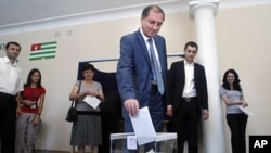 Abkhazian presidential candidate Sergei Shamba casts his ballot at a polling station in Sukhumi, Aug. 26, 2011