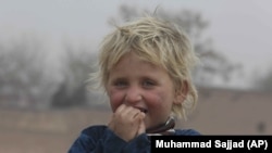 An Afghan refugee girl plays in the Kabobayan refugee camp, Peshawar, Pakistan. After 40 years, more than 1.5 million Afghan refugees still live in neighboring Pakistan. But for the first time in years, there’s a faint hope of returning home. (2/13/2020)