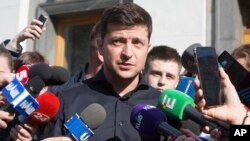 FILE - Ukraine's president-elect Volodymyr Zelenskiy answers questions from the media in front of the parliament building in Kyiv, Ukraine, May 4, 2019.
