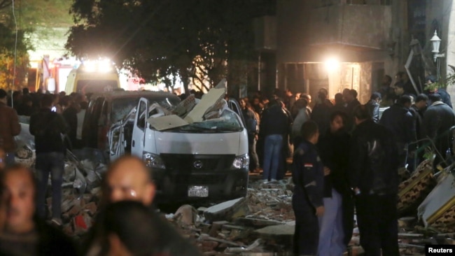 Damaged cars are seen at the scene of a bomb blast in Giza, Egypt, Jan. 21, 2016.