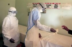 FILE: Health workers in protective suits during a training exercise for any potential coronavirus cases at a hospital in Harare, Zimbabwe, February 14, 2020. REUTERS/Philimon Bulawayo/File Photo - RC2U3F9SL1VN