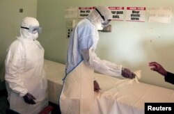 FILE: Health workers in protective suits during a training exercise for any potential coronavirus cases at a hospital in Harare, Zimbabwe, February 14, 2020. REUTERS/Philimon Bulawayo/File Photo - RC2U3F9SL1VN