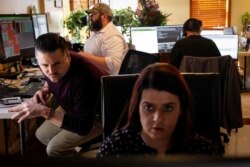 Thea D'Adamo of TradeMas Inc. works with fellow NYSE-AMEX floor traders in an offsite trading office they built in her home when the New York Stock Exchange closed because of the coronavirus, in Brooklyn, N.Y., March 26, 2020.