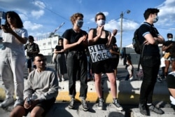 Protesters gather for a demonstration after French medical experts exonerated the gendarmes involved in the arrest of Adama Traore, a young black man who died in police custody in 2016, outside the "Tribunal de Paris" courthouse, June 2, 2020.