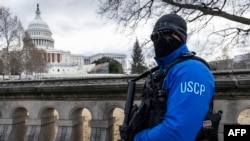 FILE - A United States Capitol Police officer stands guard on the grounds of the US Capitol building in Washington, Jan. 2, 2025. At least 14 people were killed and 30 injured on Jan. 1 when a vehicle plowed into a New Year's crowd in New Orleans. 