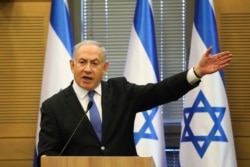 In this Nov. 20, 2019 photo, Israeli Prime Minister Benjamin Netanyahu speaks during an extended meeting of the right-wing bloc members at the Knesset, in Jerusalem.