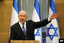 In this Nov. 20, 2019 photo, Israeli Prime Minister Benjamin Netanyahu speaks during an extended meeting of the right-wing bloc members at the Knesset, in Jerusalem.