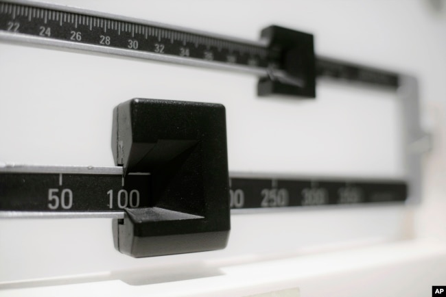 FILE - This file photo shows a closeup of a beam scale in New York, April 3, 2018. (AP Photo/Patrick Sison, File)