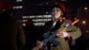 Chinese women wearing military costume march with toy guns during their daily exercises at a square outside a shopping mall in Beijing, March 24, 2015. 