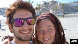 FILE - In this photograph published Jan. 17, 2019, on a Facebook page dedicated to their disappearance, Luca Tacchetto (L) and Edith Blais pose for a selfie at an unknown location.