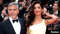 George Clooney and his wife, Amal .