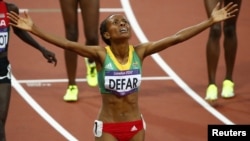 Ethiopia's Meseret Defar celebrates after winning the women's 5,000-meter final during the London 2012 Olympic Games at the Olympic Stadium, August 10, 2012.