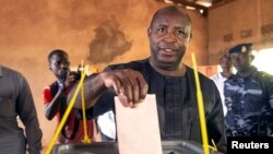 FILE - Presidential candidate Evariste Ndayishimiye of the Burundi's ruling party casts his ballot at a polling station in Gitega, Burundi, May 20, 2020.
