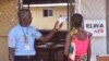 FILE - An unidentified family member, right, of a 10-year-old boy that contracted Ebola, has her temperature measured by a health worker before entering the Ebola clinic were the child is being treated on the outskirts of Monrovia, Liberia, Nov. 20, 2015