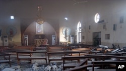 The damaged interior of the holy family Syrian Catholic Church after an early morning car bomb attack in Kirkuk, Iraq.