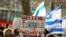 FILE - Demonstrators gather outside U.N. headquarters in New York, Dec. 4, 2023. Israeli women and legal activists criticized international rights groups' response to reports of alleged sex crimes committed by Hamas militants during the October 7 attacks.