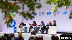 FILE - Andrea Shalal moderates an IMF roundtable on tackling public debt, during IMF Spring Meetings at the International Monetary Fund Building in Washington, U.S. April 12, 2023. 