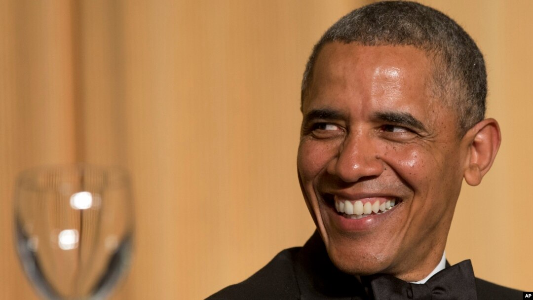 President Barack Obama laughs as actor and comedian Joel McHale speaks during the White House Correspondents' Association Dinner at the Washington Hilton Hotel, May 3, 2014, in Washington. 
