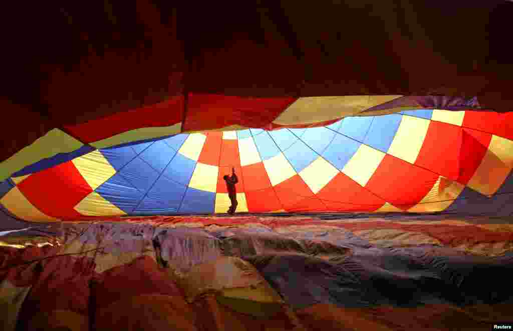 A man prepares a hot air balloon during the 2nd Hot Air Balloon Carnival in Nanjing, Jiangsu province, China, Oct. 28, 2017.