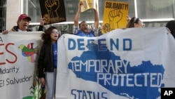 FILE - Supporters of temporary protected status immigrants stage a rally before announcing a lawsuit against the Trump administration over ending a program that lets immigrants live and work legally in the US, outside of a federal courthouse in San Francisco, Mar. 12, 2018.