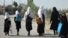 FILE - Afghan girls walk to their school in Gardez on Sept. 8, 2022. A Taliban official said on March 12, 2024, that the Taliban may permanently close girls' secondary schools, which already had been shut down in 2022.